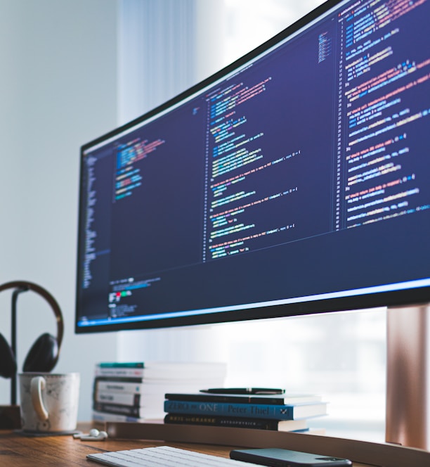 a computer monitor sitting on top of a wooden desk