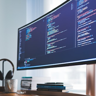 a computer monitor sitting on top of a wooden desk