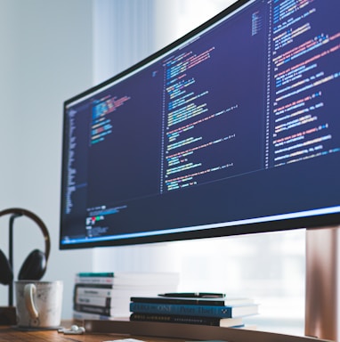 a computer monitor sitting on top of a wooden desk