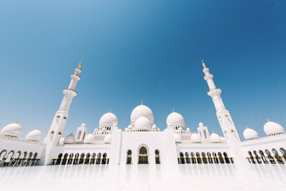 white and brown mosque under blue sky during daytime
