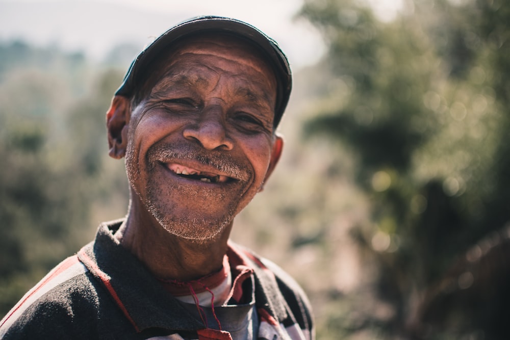 a man with a hat and a smile on his face