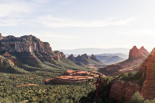Dramatic Sedona red rock formations with green forest below