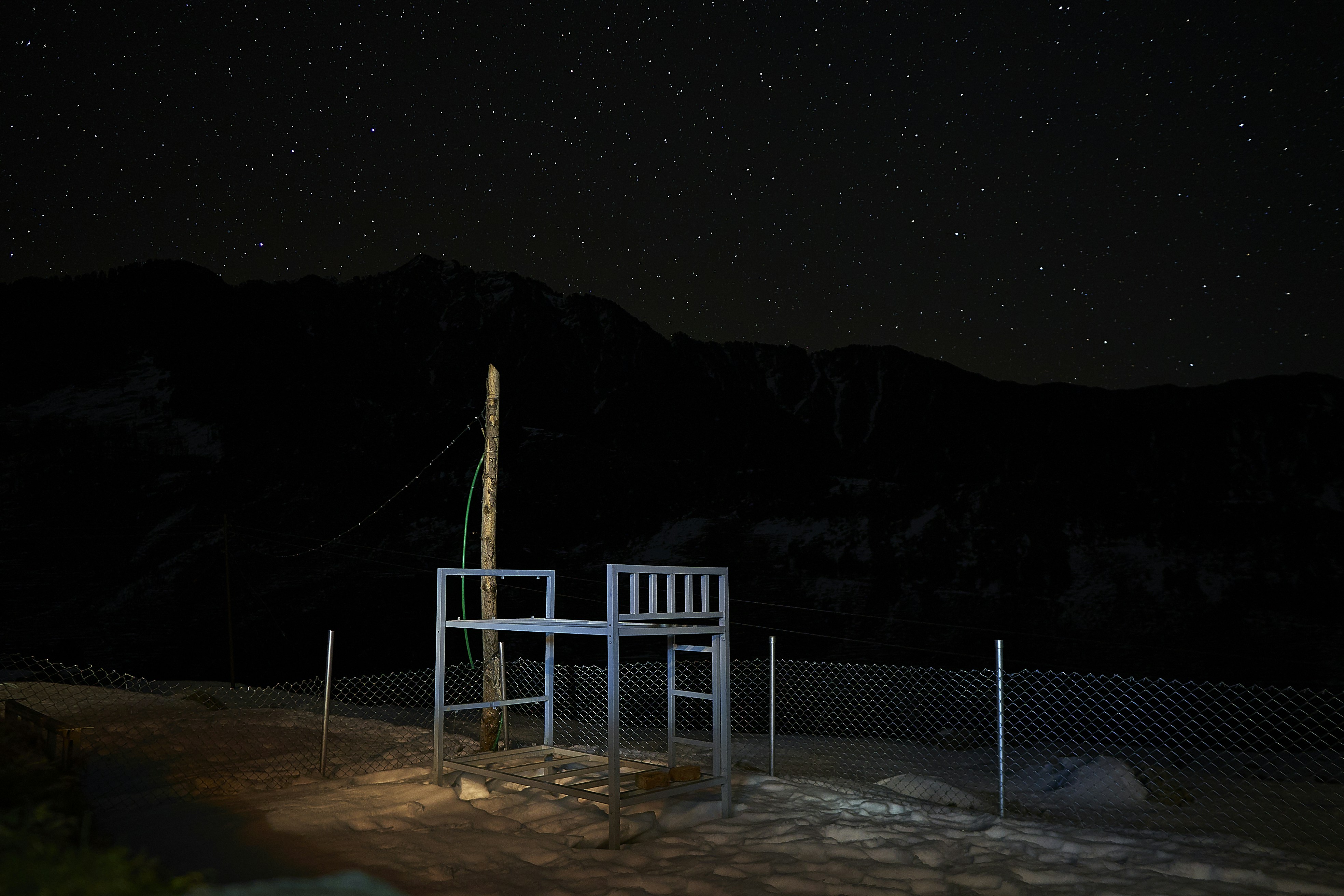 a chair sitting on top of a snow covered field
