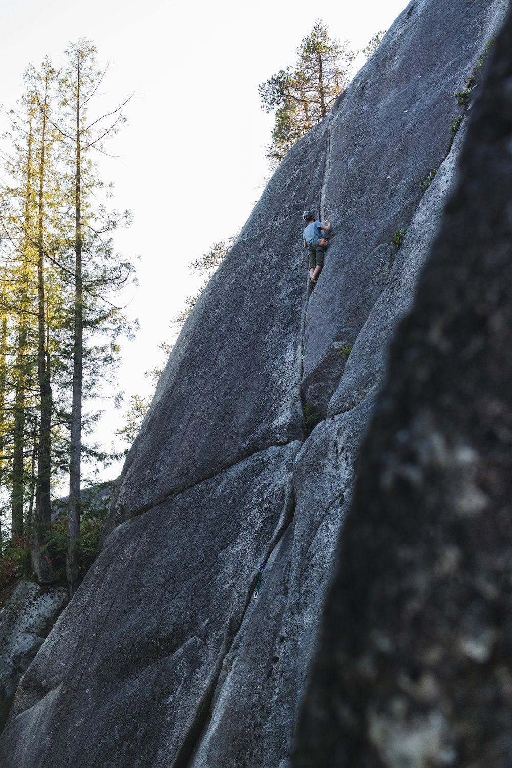 a man climbing up the side of a mountain