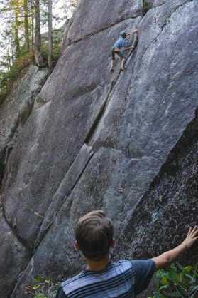 boy watching rock climber to copy movement