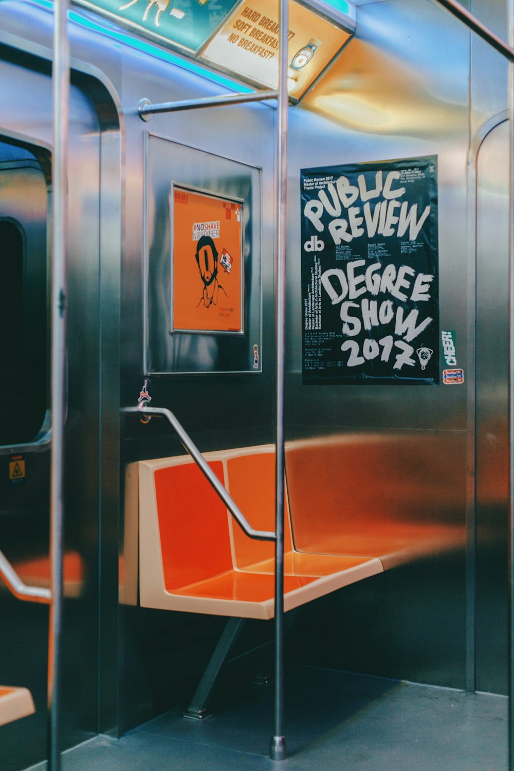 a public transit train with a sign on the door