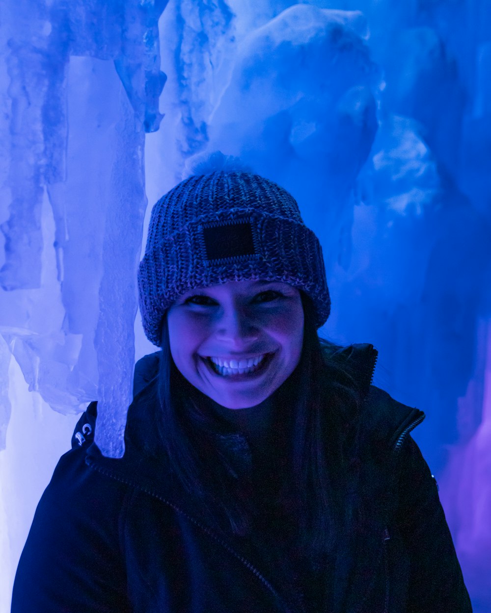 a woman standing in front of ice formations