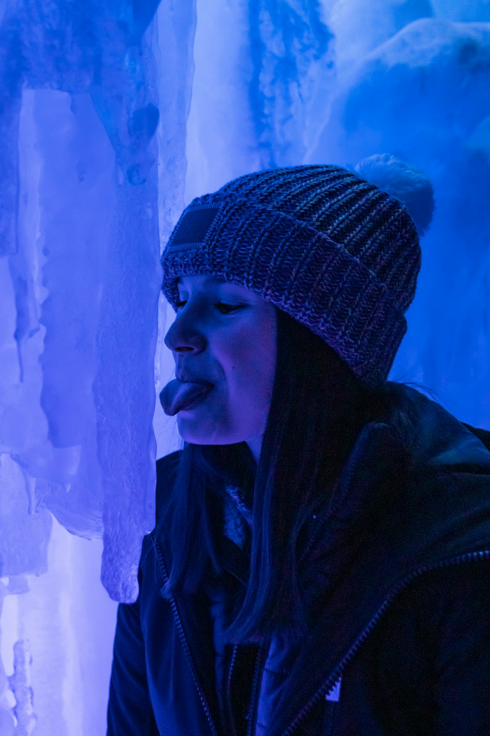 a woman standing in front of ice formations