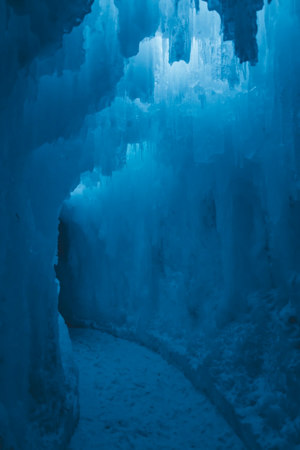 an ice cave with a walkway leading to it