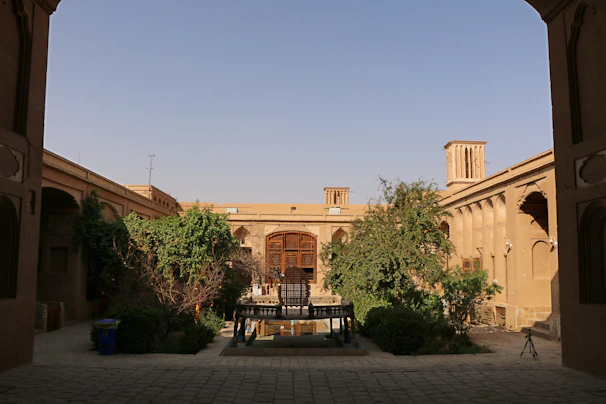 A warm Moroccan riad courtyard blending traditional design with modern technology elements.