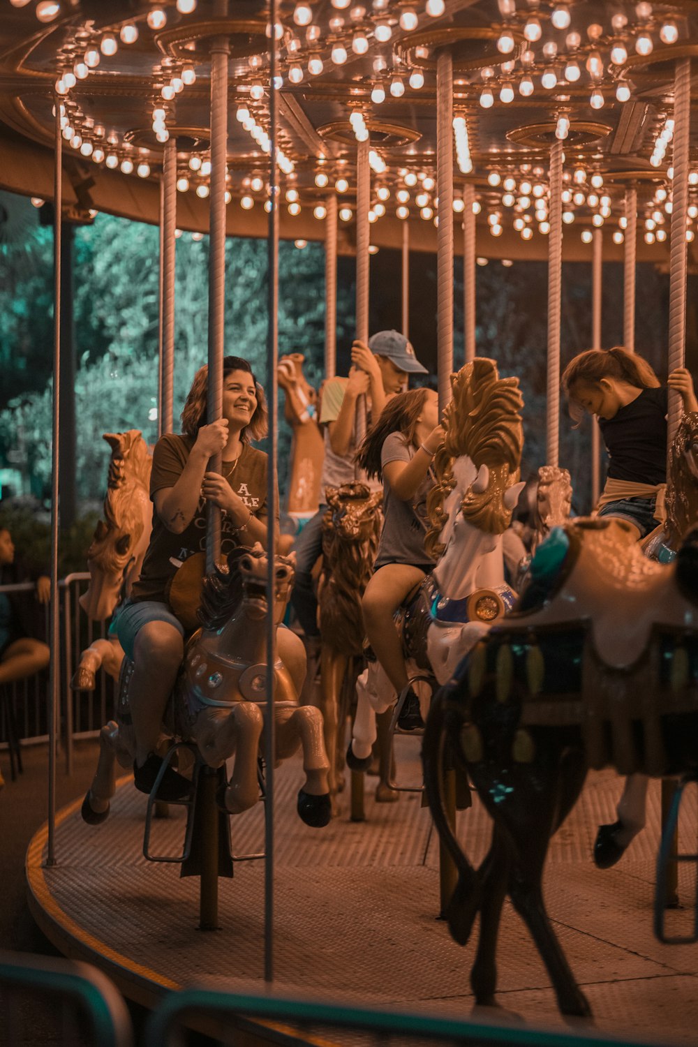 a group of people riding on top of a merry go round