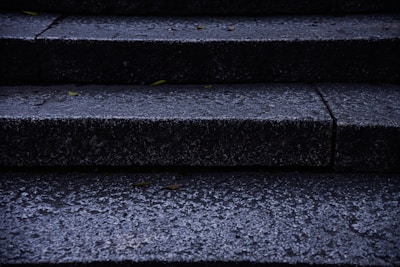 Outdoor concrete entry steps with anti-slip treatment on a rainy day.