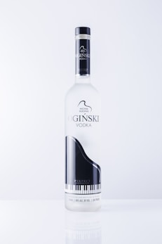 A premium vodka bottle with elegant gold accents standing against a dark background.
