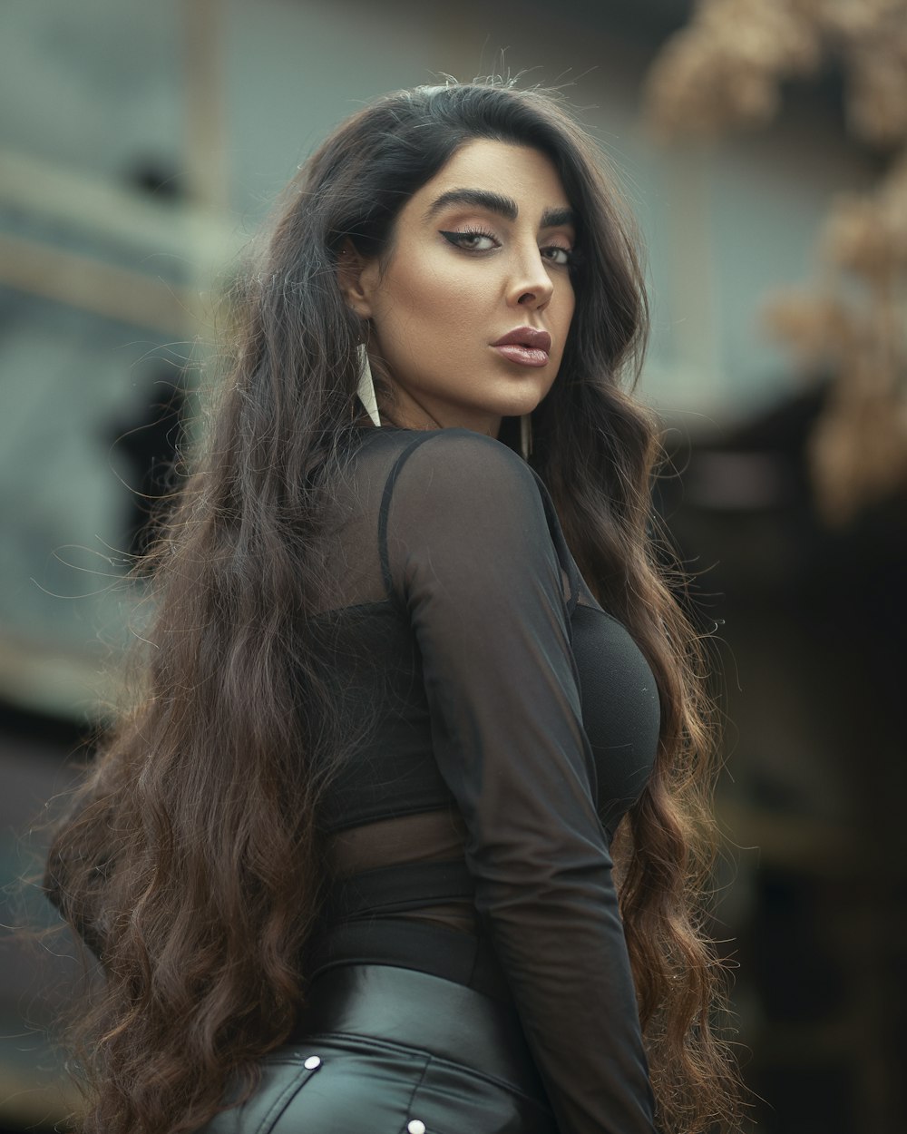 a woman with long hair wearing a black top