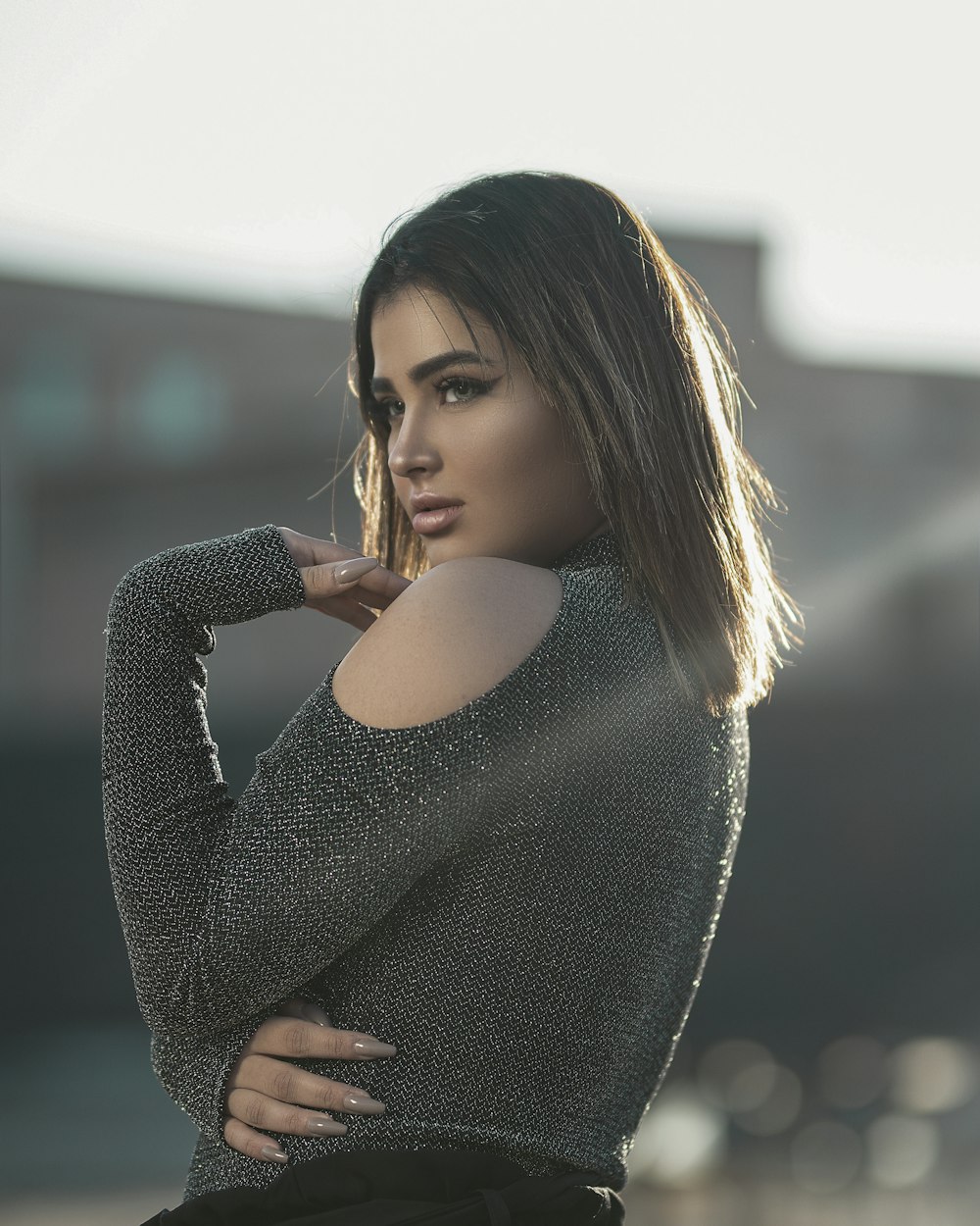 a woman posing for a picture wearing a sweater