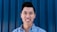 man in blue button up shirt smiling