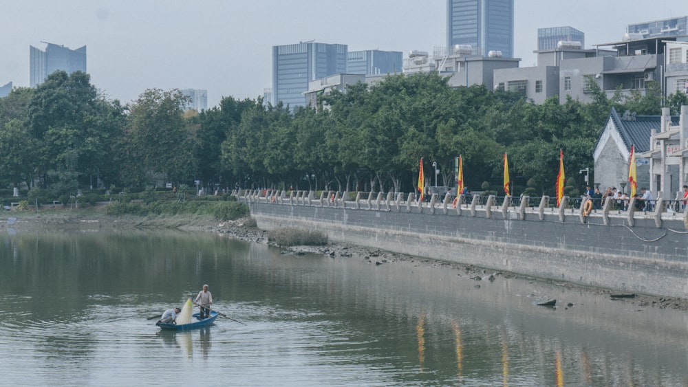 people riding on blue kayak on river during daytime