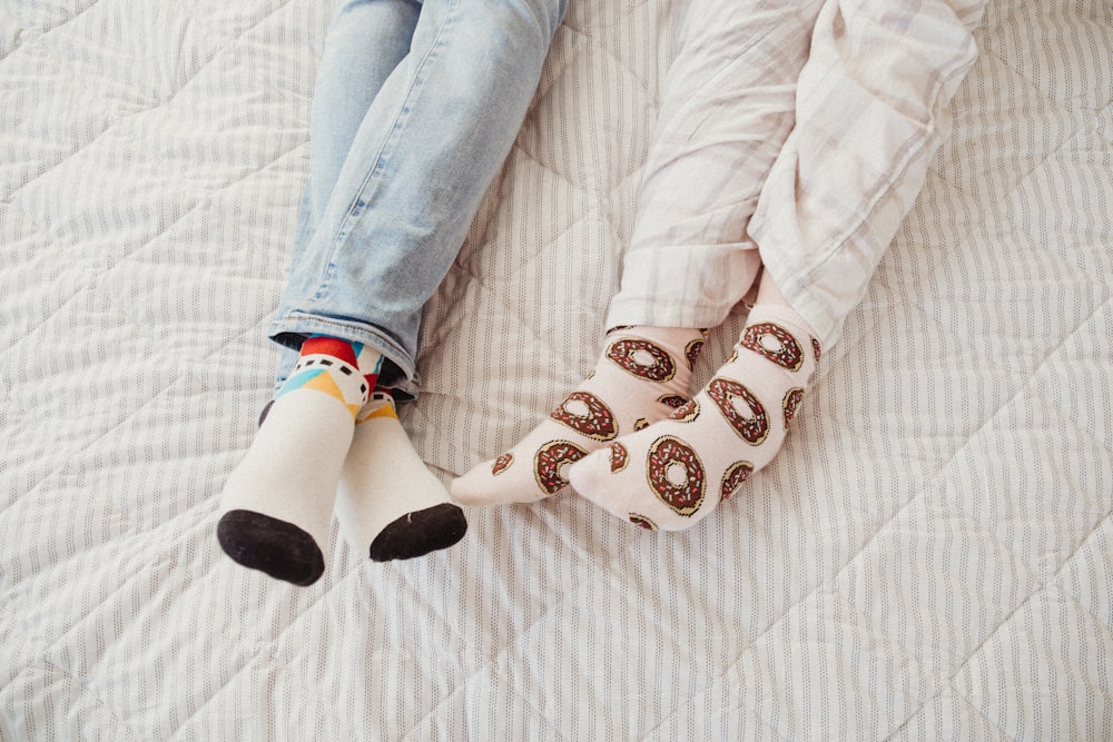 a person laying on a bed with their feet on a pillow