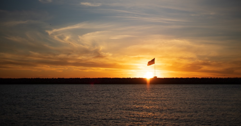 the sun is setting over a body of water