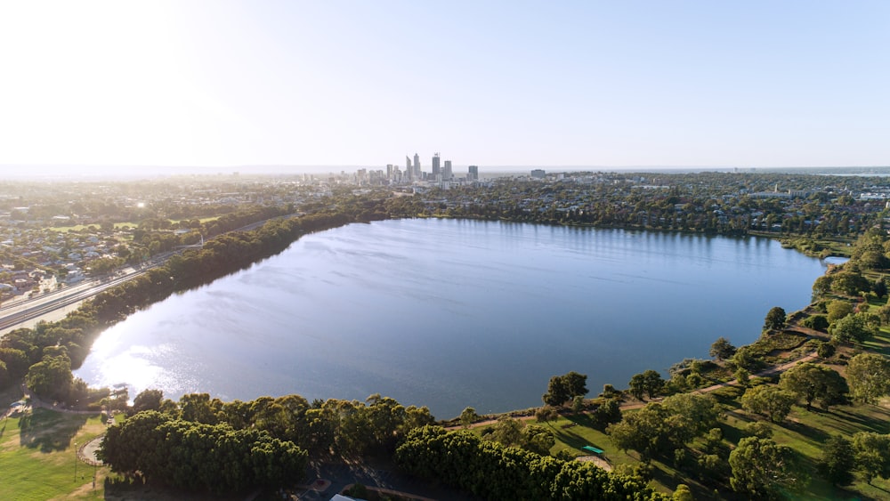 an aerial view of a lake surrounded by trees