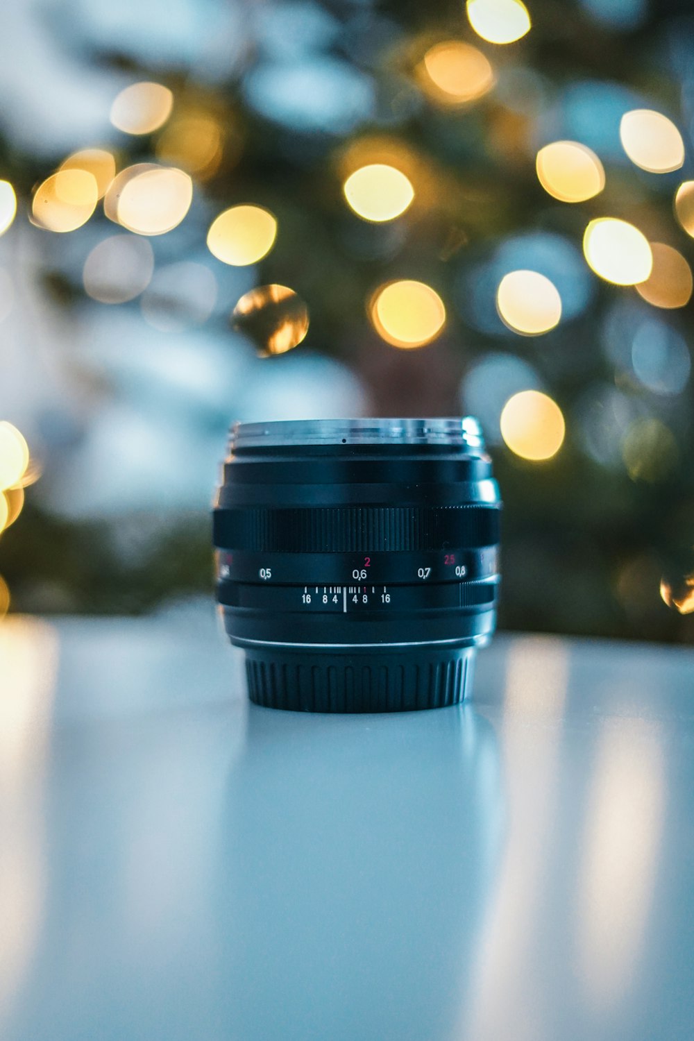 black camera lens on white table