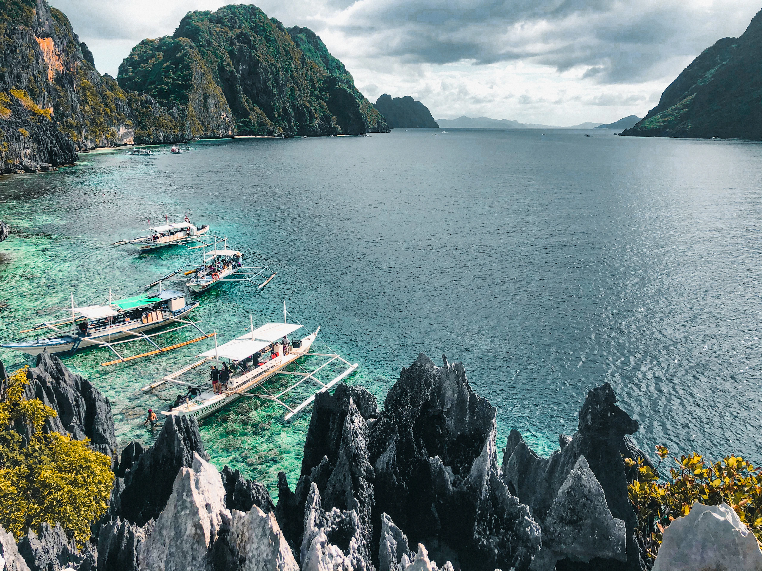 Boat at sea near a green island in the Philippines