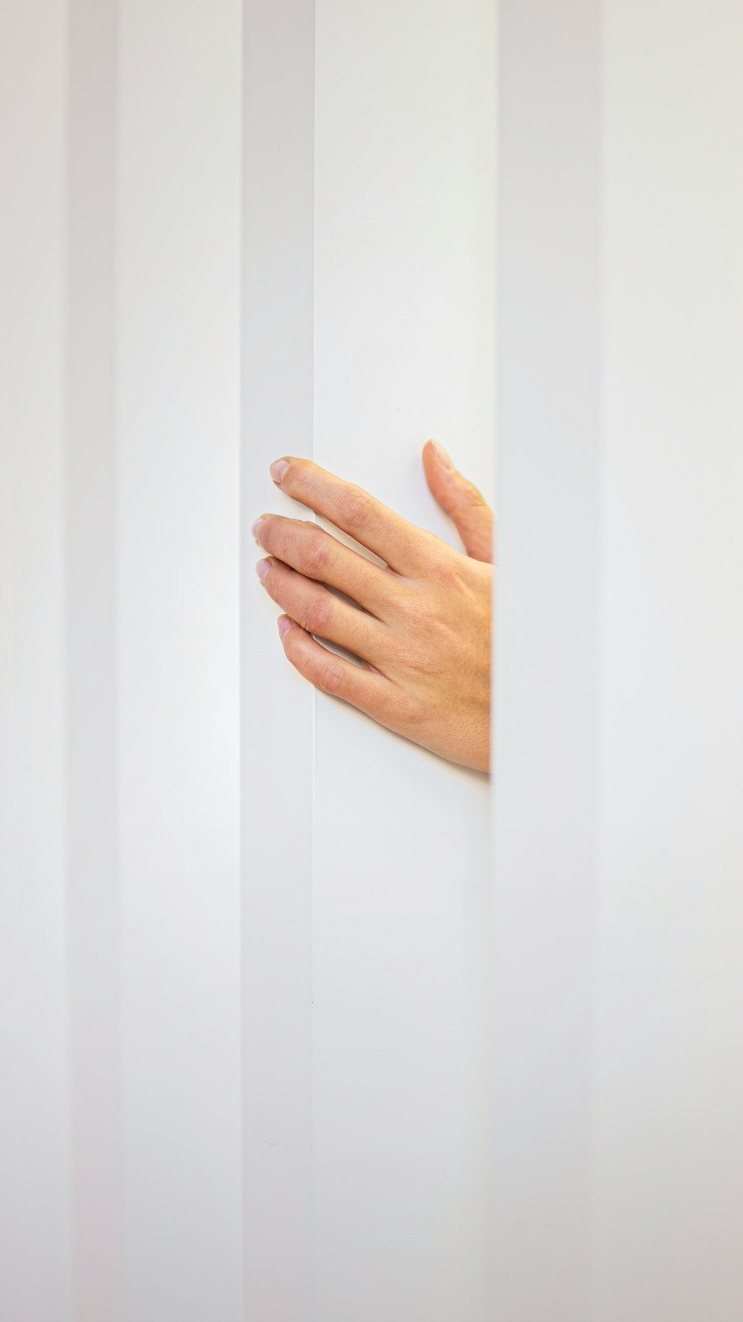 persons hand on white wall