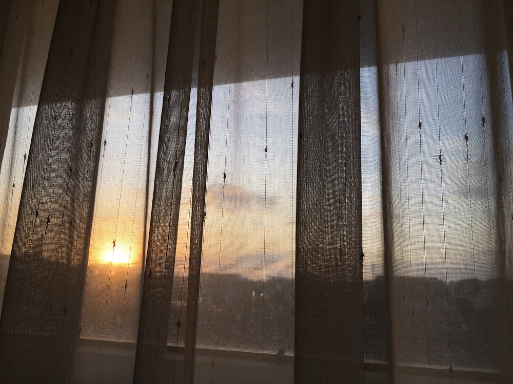 white and brown window curtain