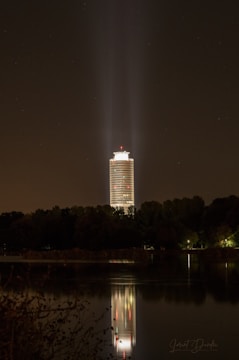 A sturdy emergency light tower illuminating a nighttime firefighting operation.