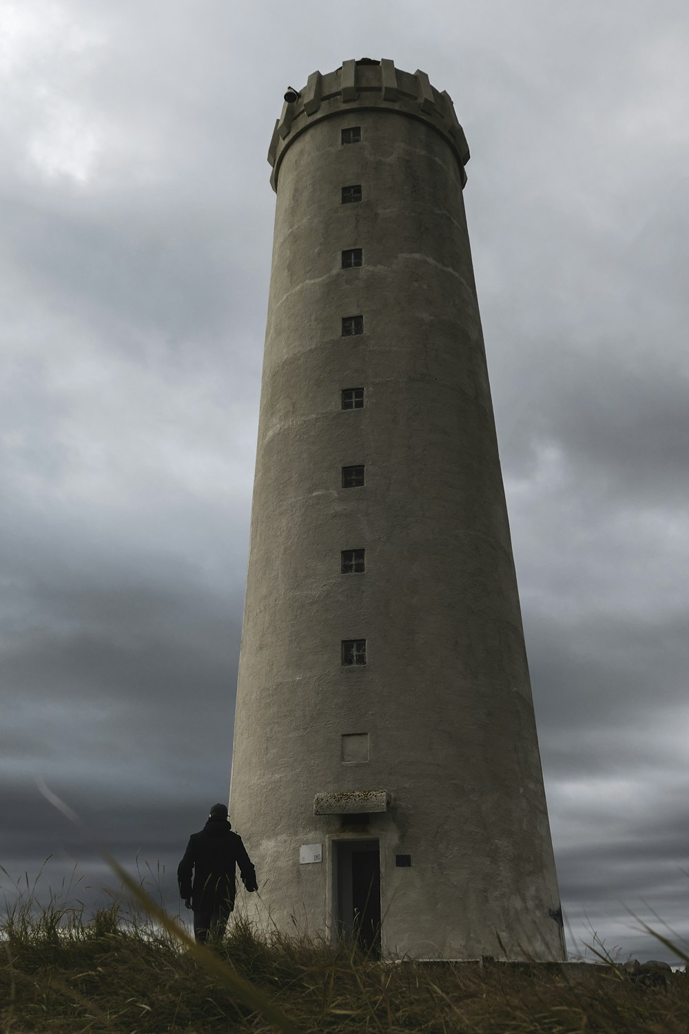 gray concrete tower under cloudy sky during daytime