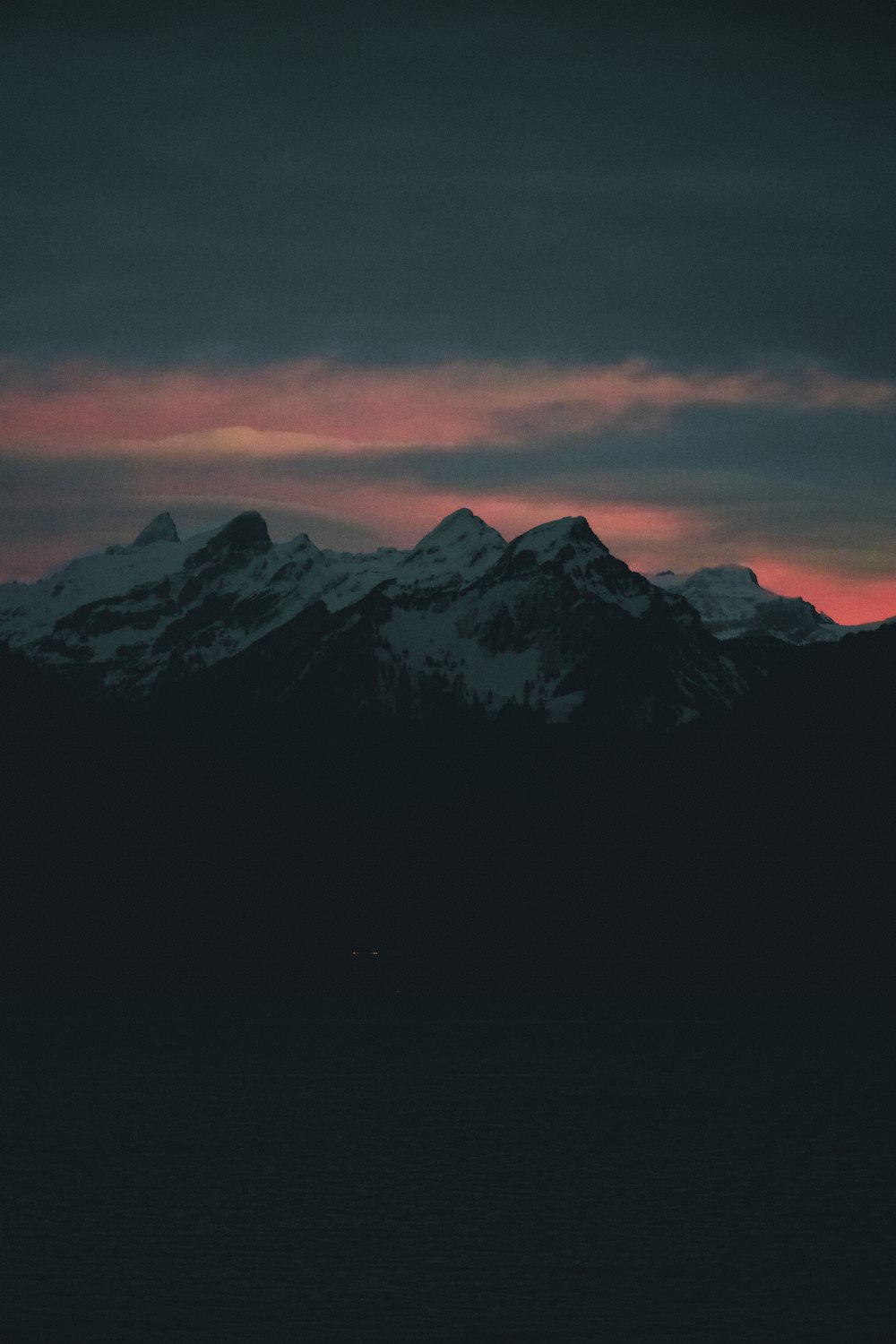 snow covered mountain during sunset