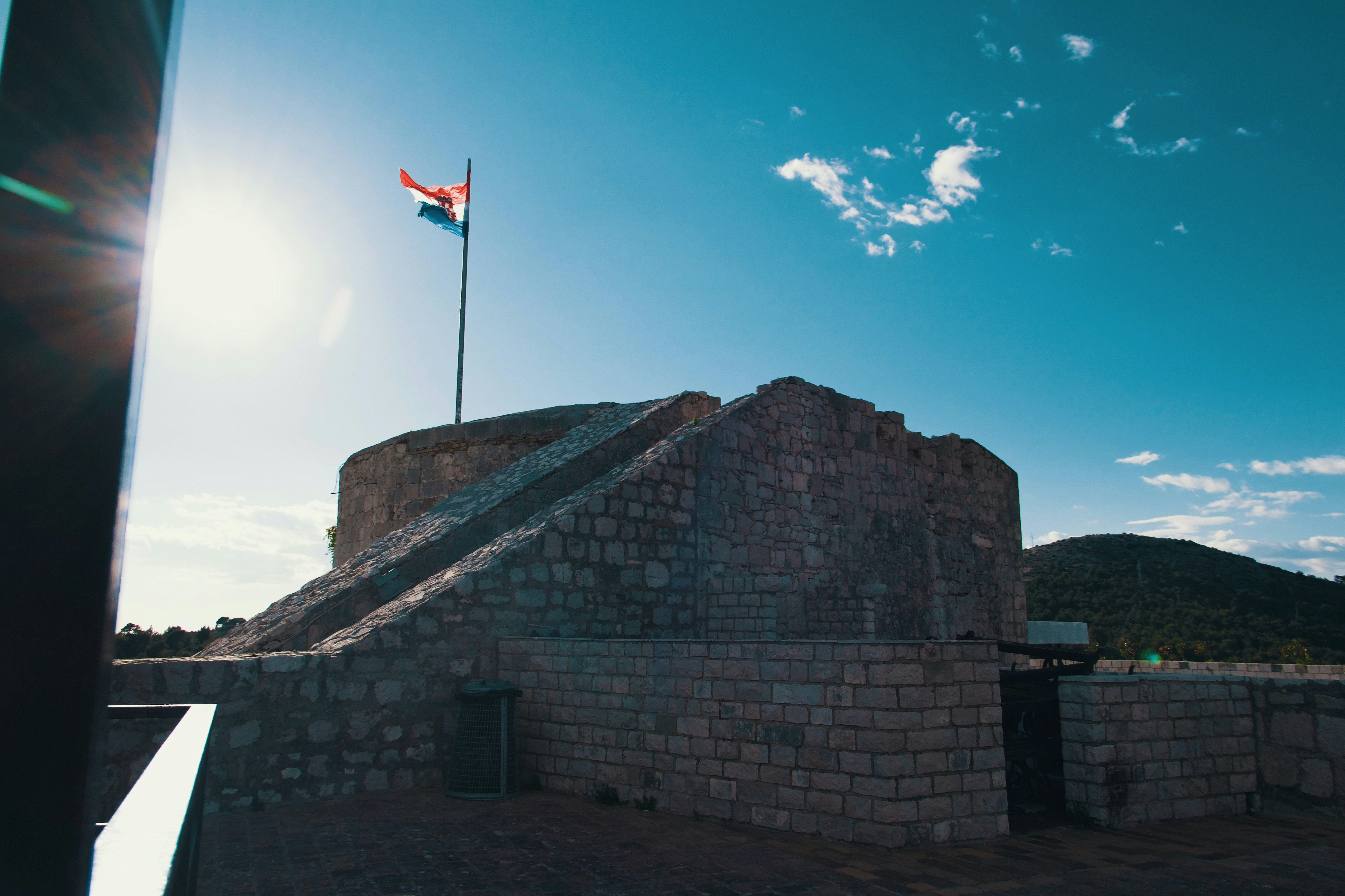 brown brick wall with flag of us a on top