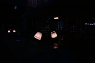 A cozy living room softly lit by a combination of sconces and floor lamps.