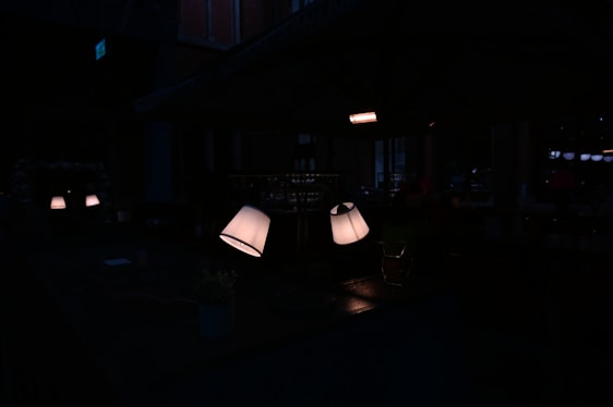 A cozy room softly illuminated by glowing smart lamps and motion-reactive LED strips in neon blue and peach hues.