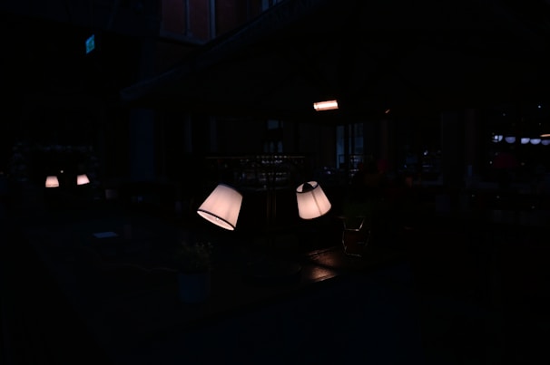 A cozy modern room softly illuminated by glowing neon blue and peach ambient lights from smart lamps and LED strips.