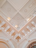 Close-up of a smooth plaster ceiling with intricate molding details.