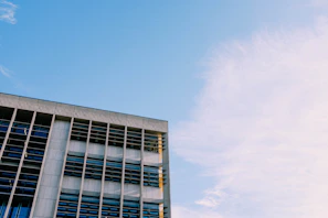 Wide shot of a modern building with visible metal framework and glass panels