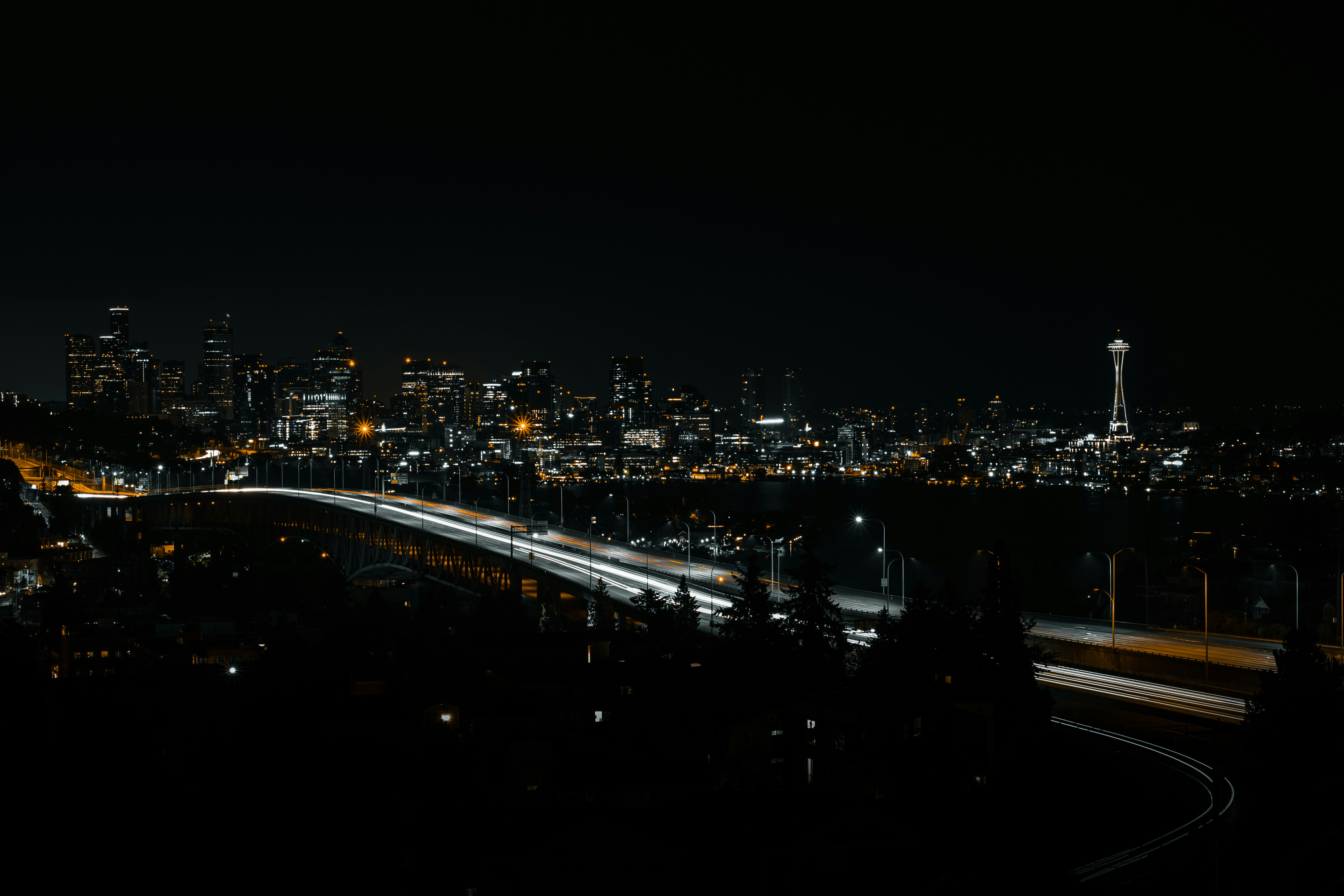 a view of a city at night from a hill