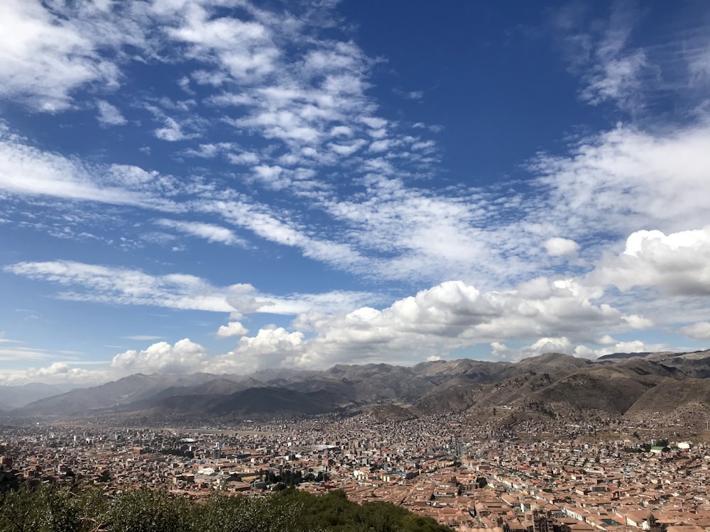 brown mountains under blue sky and white clouds during daytime