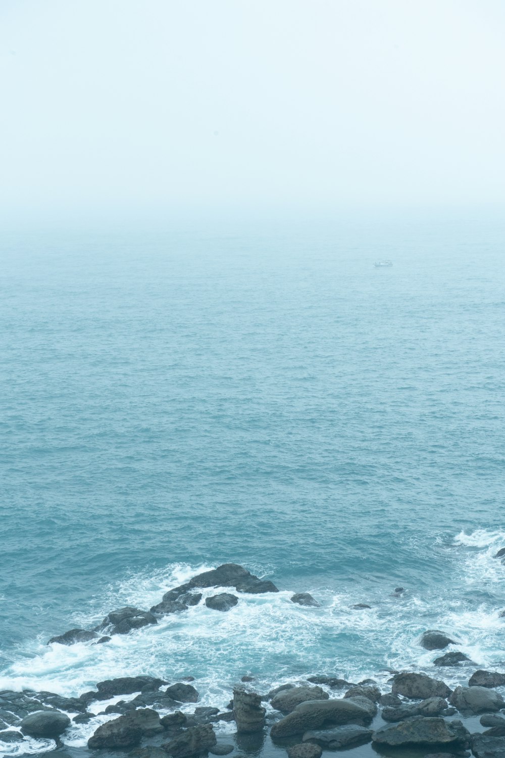 a view of the ocean from a rocky shore