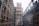 A construction site featuring tall structures covered in scaffolding, with exposed brickwork on the buildings. The scaffolds form a grid pattern around the buildings. The scene appears industrial and shows early stages of development.