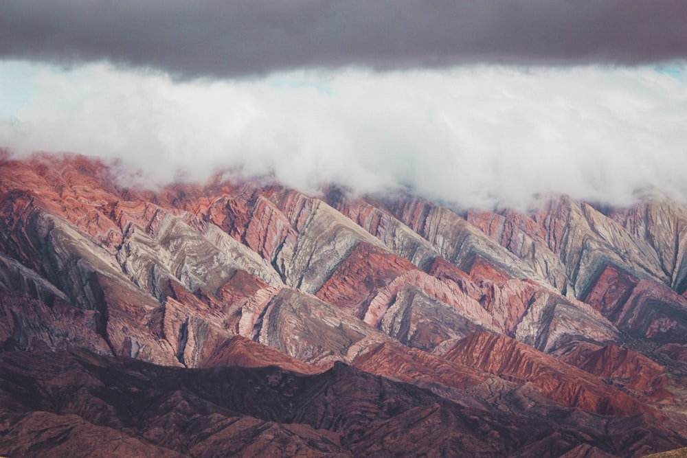 brown and gray mountain under white clouds