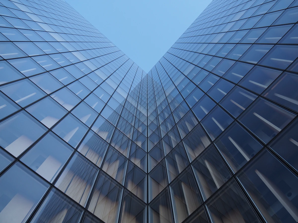 Low-angle view of a modern high-rise commercial building with glass facade