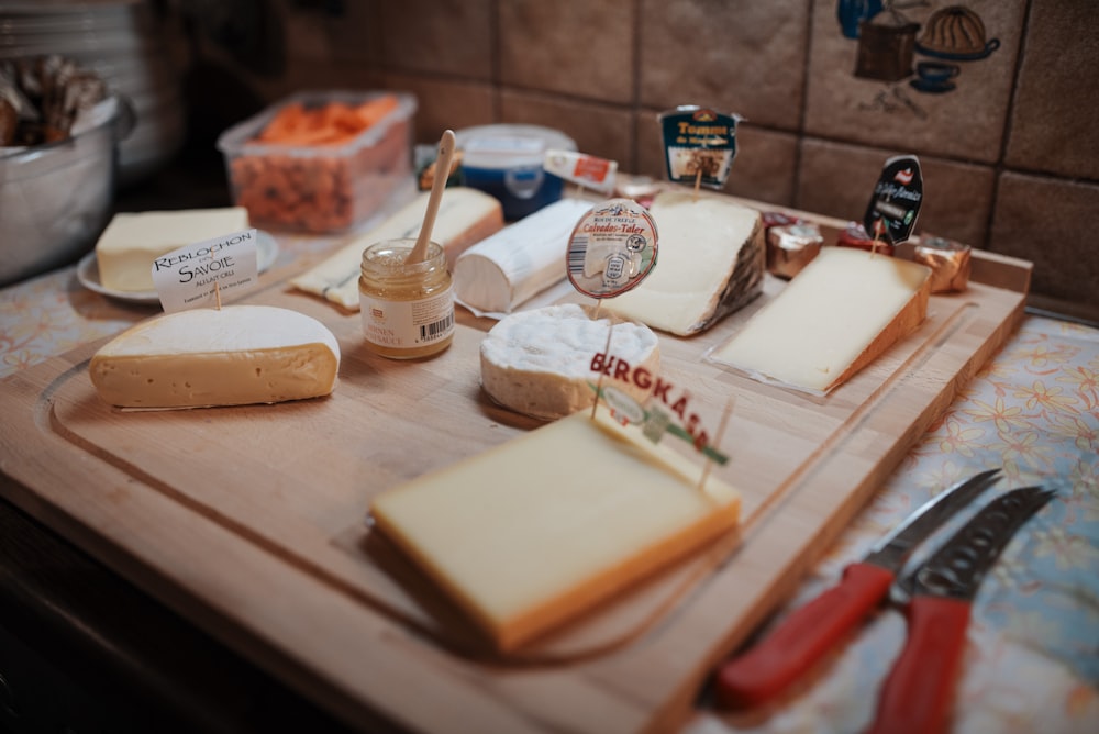 white and brown cheese on brown wooden chopping board