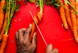 Close-up of vibrant, freshly cut carrots neatly arranged on a wooden board.