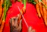 Close-up of a hand using a sleek peeler on a fresh carrot over a white kitchen counter.
