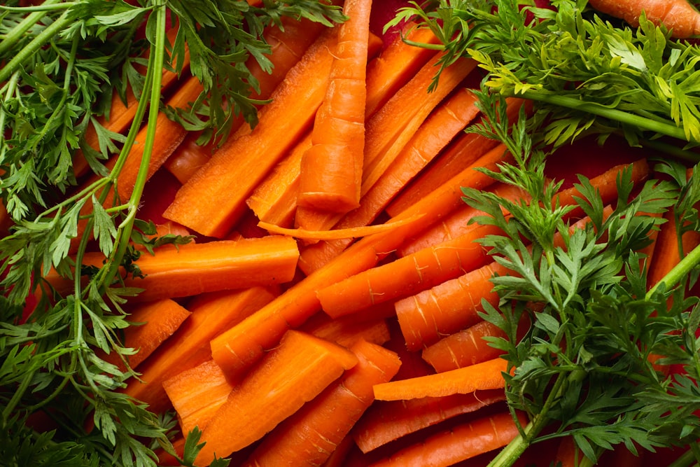 a pile of carrots and parsley on a table
