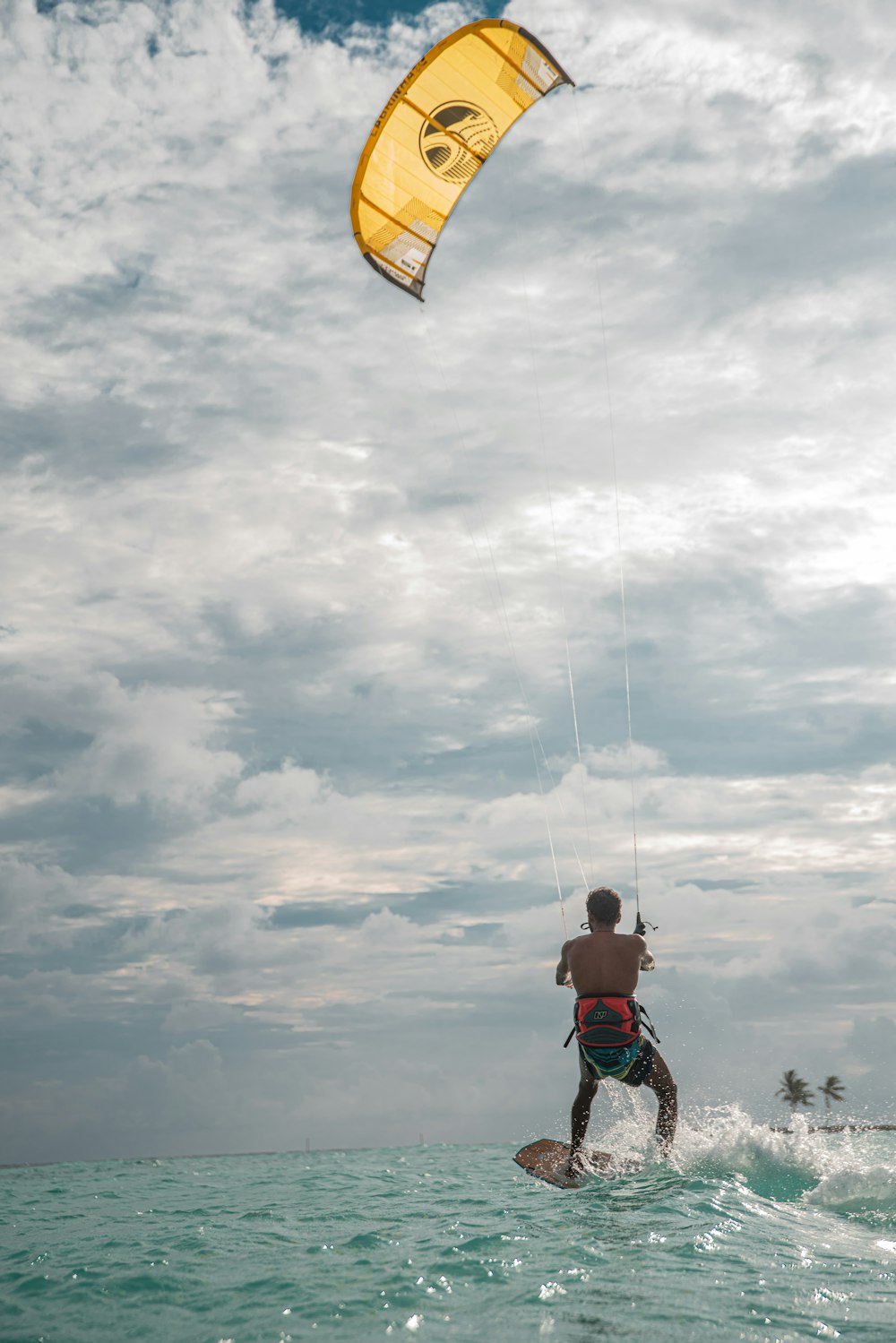 a man riding a kiteboard on top of a body of water