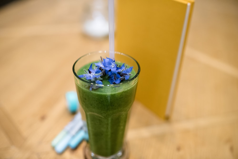 green liquid in clear drinking glass