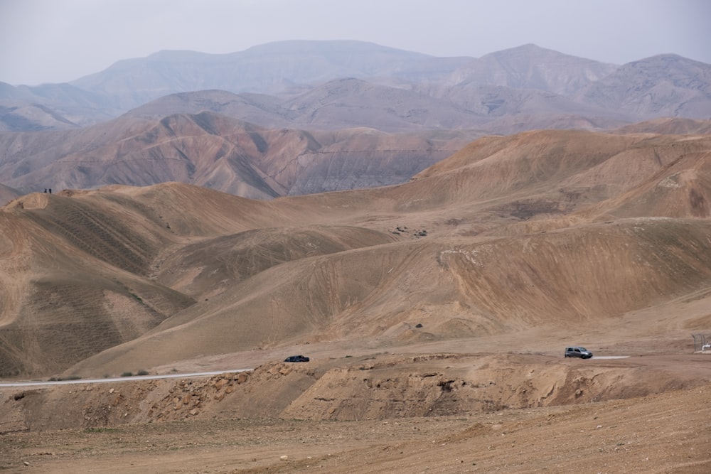 black car on brown field during daytime